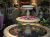 Carol admires the flowers at Bangkok Hotel